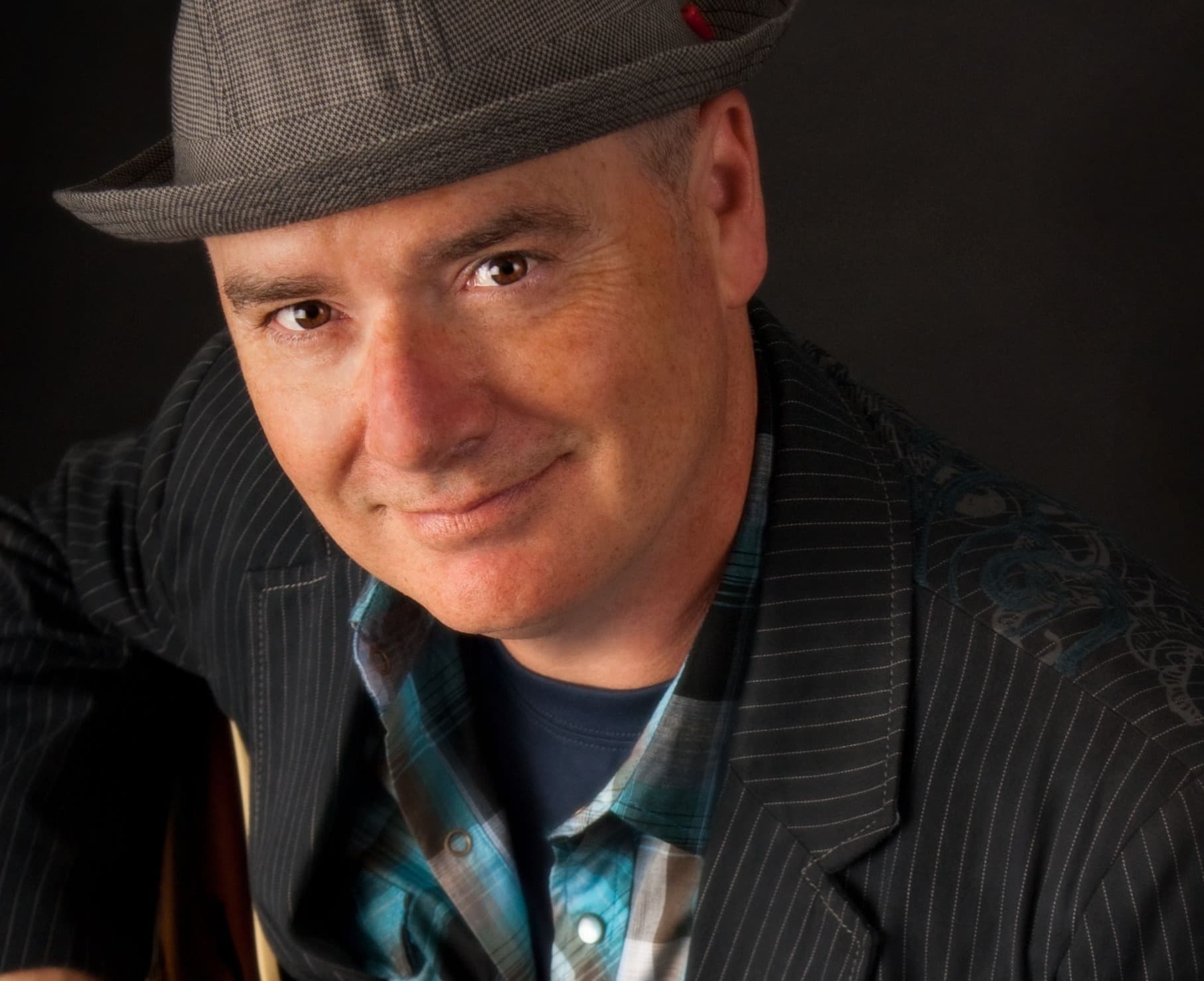 Robert Walsh looks to camera wearing a hat